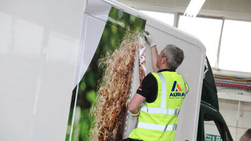 Aura Brand Solutions Fitter installs vehicle wrap