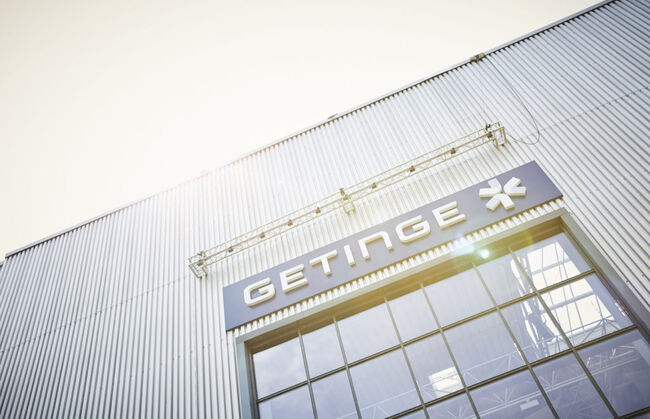Brightly lit image of exterior signage above entrance to Getinge offices